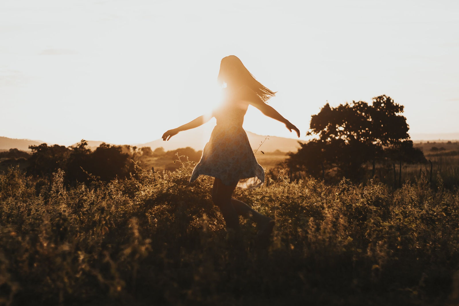Women dancing outdoors in a field