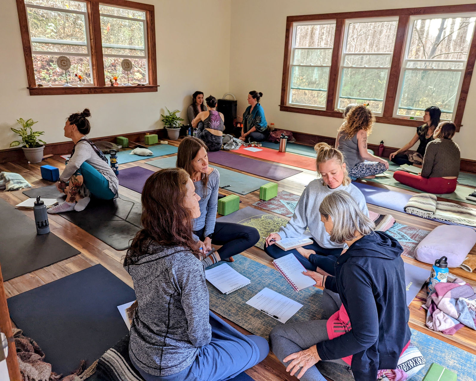 Women seated on mats in a sunlit studio during a workshop